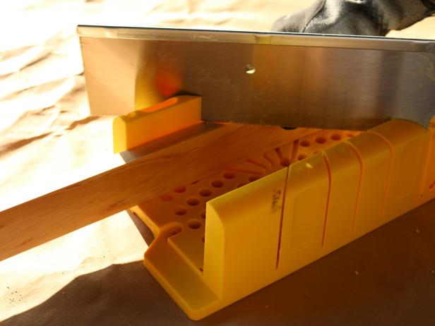Next, cut the trim to size, then miter the edges using saw and miter box.