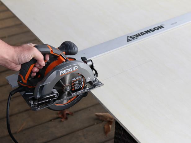 Once the plywood is marked with pencil, add a straight edge and guide the circular saw or table saw along the marked line. Itâs best to have a helper assist in keeping the wood held securely in order to help guide it through the saw safely.