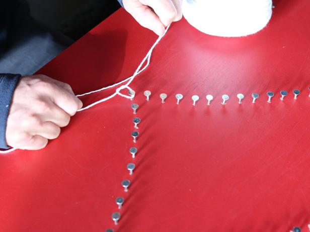 To start the stringing process, first knot string to one nail.