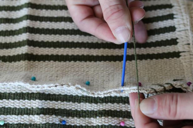 Thread round-ended tapestry needle with mercerized cotton then sew the bottom panel to the three of the four side panels.