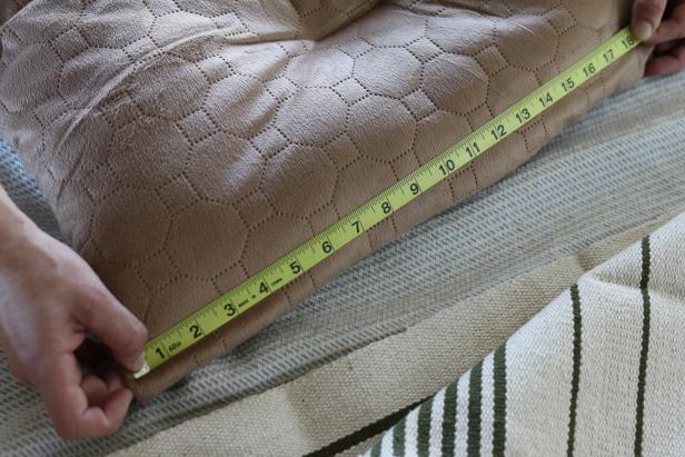 Lay the pet bed out on a flat level surface then use the measuring tape to determine its length and width.