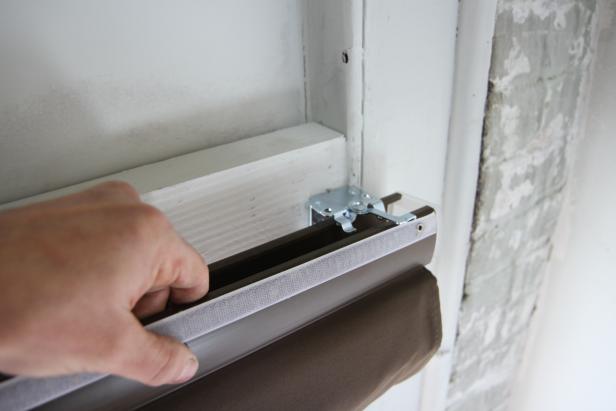 Insert the front edge of the shade headrail onto the front hooks of all three mounting brackets.