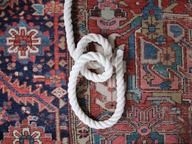 A running bowline is a great knot to secure the rope to the tree limb. Make the knot by first forming two loops, as shown.