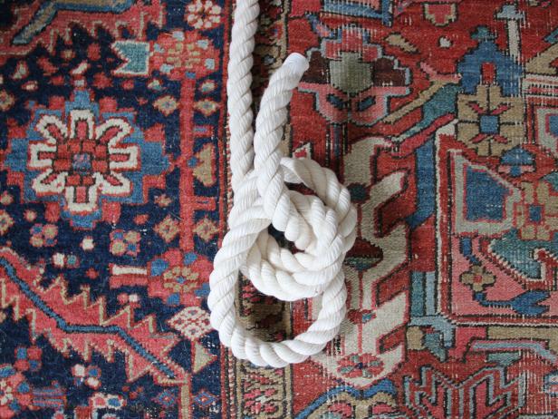Bring the loose end under the two loops and up through the center.