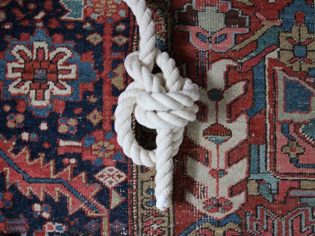Thread the loose end down into the center of the two loops.
