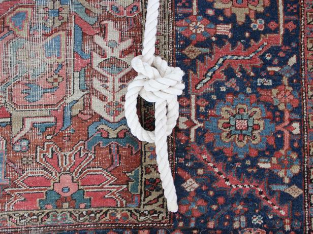 Pull the long end and the loose end apart to tighten the knot, which will form a small loop at the bottom below the knot.