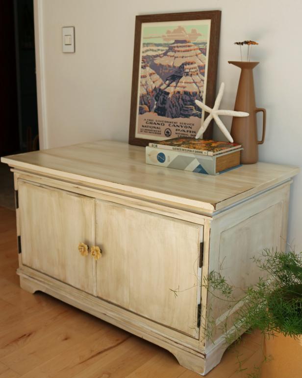 A cabinet distressed with paint and stain so as to be rustic and vintage-like.