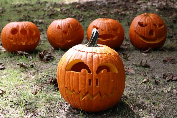 Carve and stack pumpkins onto a fence post to make an unique pumpkin totem pole.