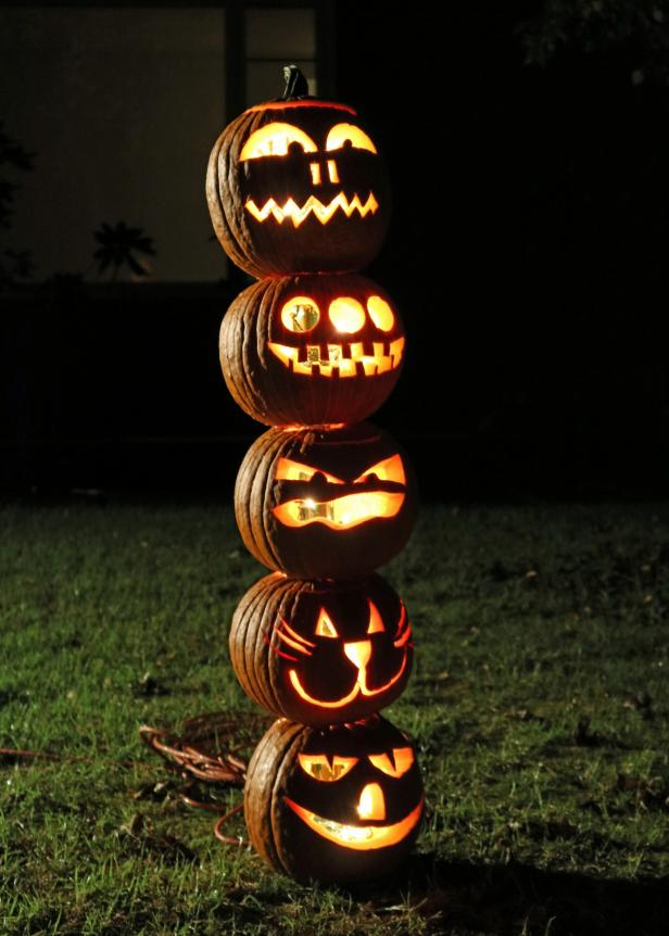 Make a carved pumpkin totem pole for outdoor Halloween decor. Make a carved pumpkin totem pole for outdoor Halloween decor.