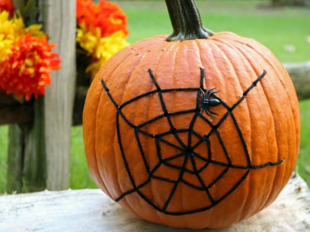 Pumpkin decorated with a spiderweb design for Halloween decor. Pumpkin decorated with a spiderweb design for Halloween decor.