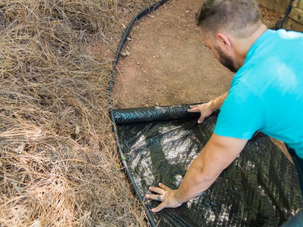 Step 4- Roll Out Weed BlockNext, roll out a weed block material over the pathway. Stake all the loose edges and trim excess with scissors.