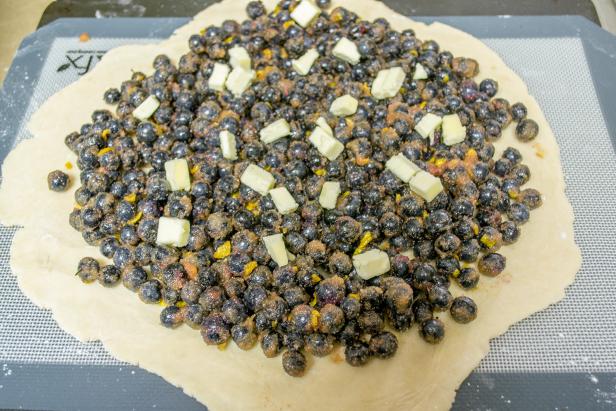 Add the Blueberries and Pats of Butter to the Rolled Out Pie Crust Add the Blueberries and Pats of Butter to the Rolled Out Pie Crust