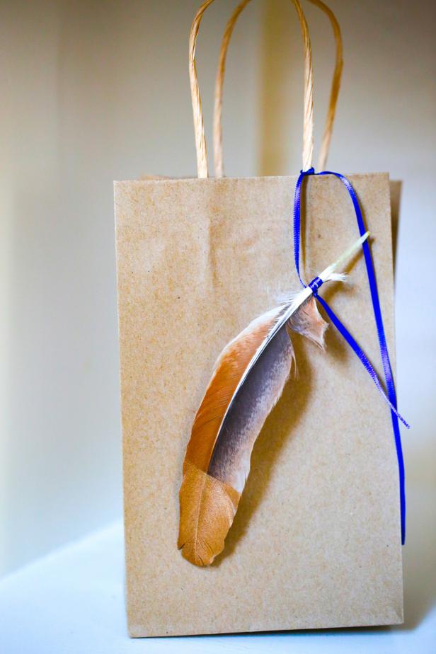 A Gift Bag Embellished with a Golden Feather A Gift Bag Embellished with a Golden Feather
