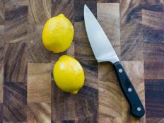 Wood Cutting Board, Two Lemons and a Knife