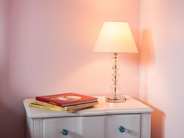 Glass Lamp on a White Bedside table in a Pink Girls Bedroom Glass Lamp on a White Bedside table in a Pink Girls Bedroom