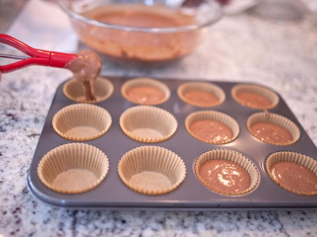 Scoop Batter Into Cupcake Liners Adding Chocolate Batter to Cupcake Liners With Cookie Scoop
