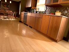 Side view of bamboo flooring in kitchen area - this type of flooring is environmentally friendly. Bamboo is one of the strongest materials around. It is also a fast-growing regenerating plant. It has the strength of steel. It is a highly durable floor that resists contraction and swelling. 