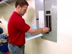 A home inspector checks the electrical system in a home.