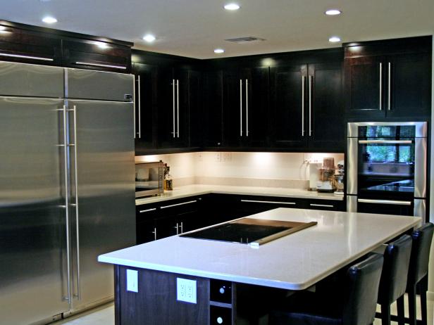 Kitchen With Dark Cabinetry, Oversized Hardware, White Countertops