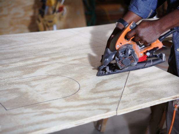 A circular saw is used to cut panels for a DIY doghouse.