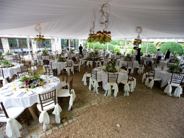 A tent is elegantly decorated with lighting fixtures for a wedding reception at Blackberry Farm.