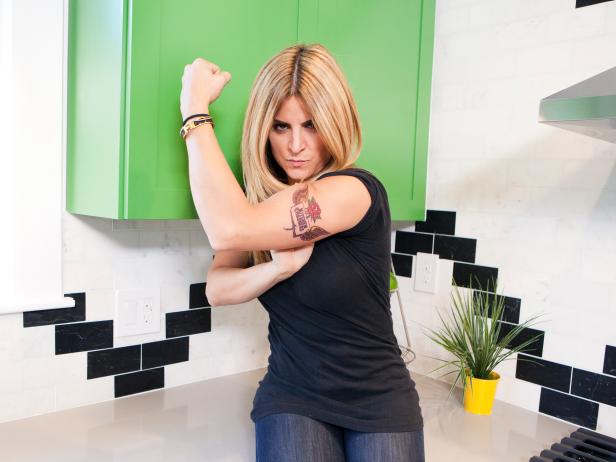 DIY Network's Kitchen Crashers host Alison Victoria, as seen in Nick and Sarah Colella's newly redesigned kitchen, showing off the Kitchen Crashers tattoo Nick painted on her arm...