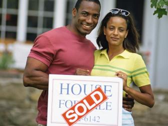 Couple posing together in front of house