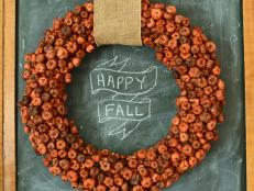 Instead of making a wreath with bulky plastic gourds, try using putka pods, which are natural, dried seed pods that look exactly like tiny pumpkins.  When hot glued over a foam wreath form and embellished with a pretty ribbon, it makes an elegant statement for fall that can be used year after year.