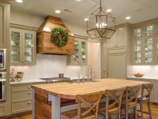 HGTV Remodels Room Stories Transitional Kitchen with butcherblock island and glass-front cabinets.