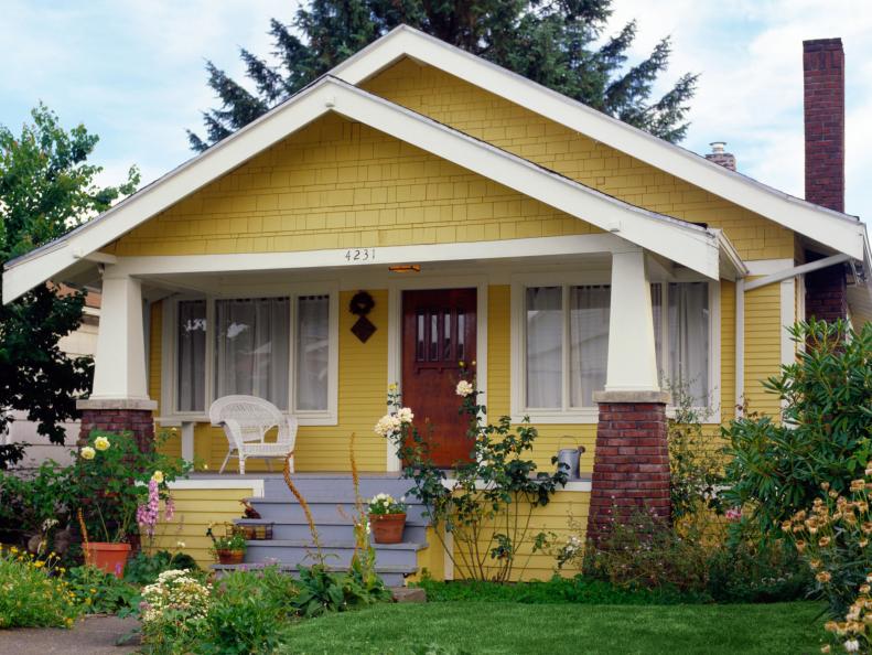 Yellow bungalow style house with garden, exterior view