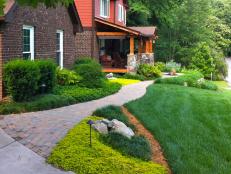 Landscaper Eric King maintains that less is more with a design approach that hides unnecessary distractions like an a/c unit, leads your eye naturally to the highlights and reduces clutter to create an welcoming effect like this pathway to the front porch entrance.