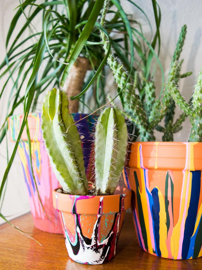 You might cry over spilled milk, but you will rejoice when spilling paint on these fun planters. Grab an old pot, a funky color combo of cheap craft paint and get to spilling.  Better yet if you have small children, let them do the spilling for you.