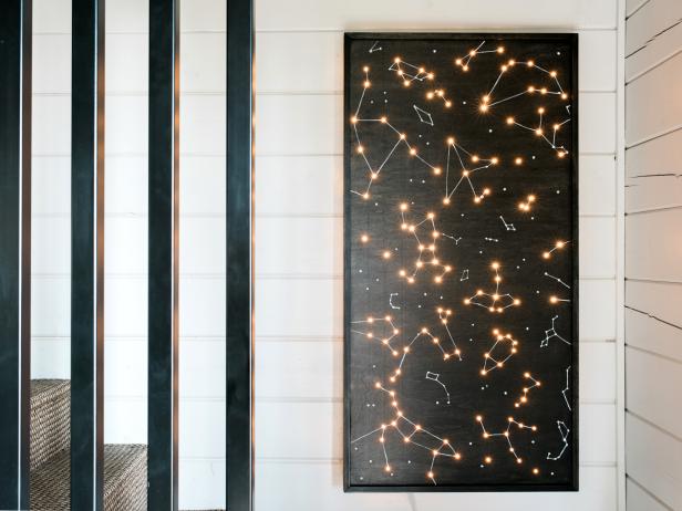Create modern art that doubles as ambient lighting from plywood, trim and twinkle lights.