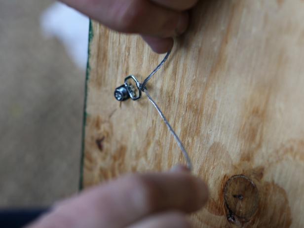 Use drill to attach picture hanging hardware to the back of the plywood.