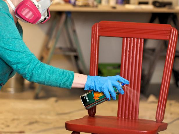 A polyurethane clear coat gives an added layer of sheen and hardens and protects the paint. Match oil-based top coats with oil paint and water-based top coats with water-based paint. Hold can 10-12â   away and spray using a back and forth motion. Follow the natural lines of the chair to coat it evenly. After the first clear coat dries, lightly sand with 200 grit or higher sandpaper for a professional finish before spraying on the final coat.