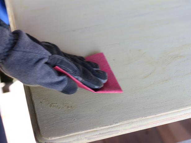Before new paint can be applied, youâ  ll need to rough up and/or remove the existing finish. Use fine grit sand paper to knock the existing sealer loose. Once the entire surface has been sand-ed, be sure to wipe the dresser clean using a damp cloth.