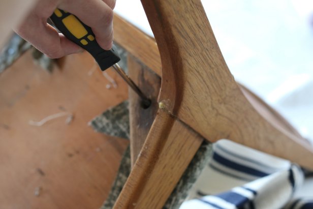 Use a drill or screwdriver to remove the existing chair cushion.