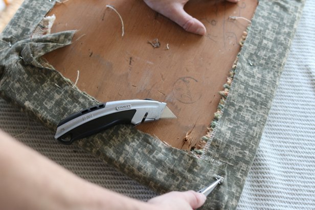 Remove the existing fabric from the chair cushion using a utility knife and/or needle nose pliers.