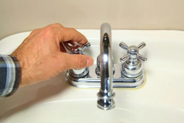 Open a hot water tap nearest to the water heater, preferably on the floor above. This alleviates pressure in the system, allowing the water to drain quickly from the tank, much like removing your finger from the top of a drinking straw filled with liquid.