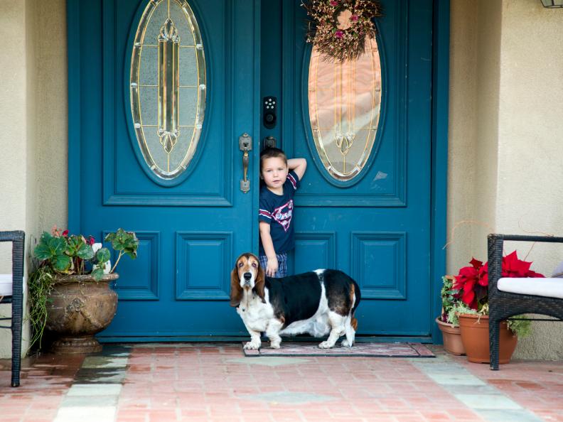 Chance Hoofard (4) with the family dog, Maggie, in the Hoofard’s front entrance before any work is done by host and licensed contractor Jason Cameron, as seen on America’s Most Desperate Landscape.