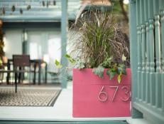 Up your curb appeal with this stylish planter featuring modern house numbers and a bold color.