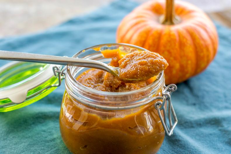 jar full of pumpkin butter with a spoon