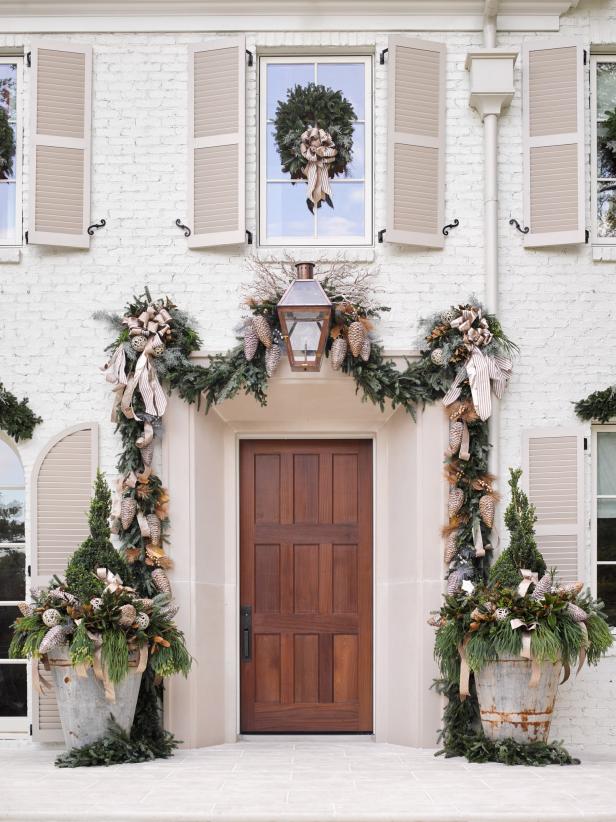 White brick French Country Atlanta showhouse 2016 decorated for Christmas with garland and zinc pots