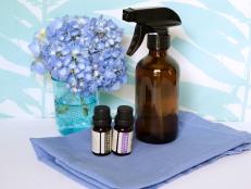 Brown Spray Bottle with Essential Oil Bottles and Blue Hydrangea Flower