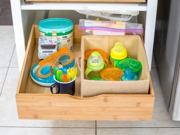 Keep Them Distracted: 

Brightly colored plastic bottles and containers that you deem safe can be kept in a bottom shelf or cabinet. This could keep baby engaged while meals are being prepared.