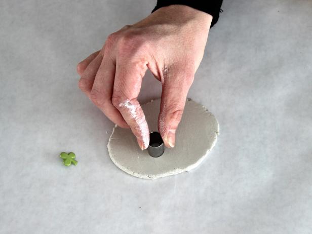 Press the small circle into the clay. Remove the cut circle of clay.