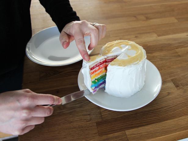 Cut into the cake with a sharp knife to reveal the rainbow layers and make a lucky wish!
