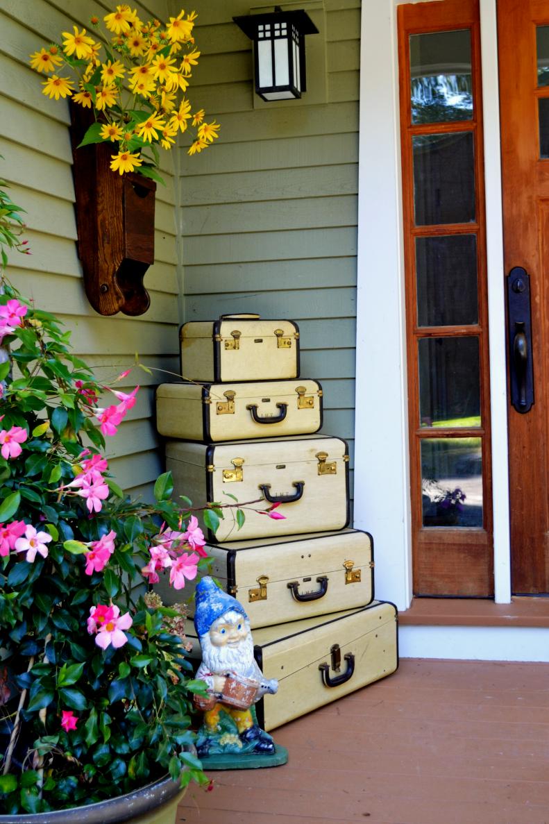 Vintage Suitcases and a Garden Gnome on a Porch