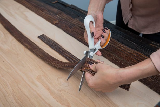 Lay out the design of your leather belts on the headboard.