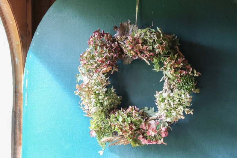 The wreath hangs on the front door.
